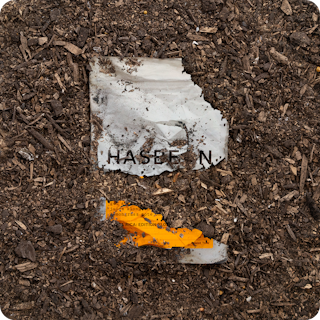 Compostable packaging from Hasbean coffee decomposing in soil